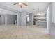 Open-concept living space featuring a kitchen, living area, tile floors, and natural light at 180 Duck Hollow Ave, Las Vegas, NV 89148