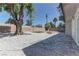 Spacious backyard features a rock garden, mature trees, a patio, and privacy fence at 1901 Farnam Pl, Las Vegas, NV 89102