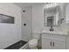 Modern bathroom features white marbled tile shower and black hardware, with white vanity at 1901 Farnam Pl, Las Vegas, NV 89102