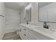 Modern bathroom with dual sinks, white cabinets and a shower/tub combo at 1901 Farnam Pl, Las Vegas, NV 89102
