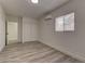 Bright bedroom includes wood-look floors, window, fresh neutral paint and a closet at 1901 Farnam Pl, Las Vegas, NV 89102