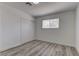 Bright bedroom includes wood-look floors, window, fresh neutral paint and a closet at 1901 Farnam Pl, Las Vegas, NV 89102