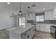 Bright kitchen features a large island, stainless steel appliances, and modern pendant lighting at 1901 Farnam Pl, Las Vegas, NV 89102