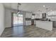 Open-concept kitchen featuring stainless steel appliances, island, and sliding glass door to backyard at 1901 Farnam Pl, Las Vegas, NV 89102