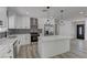 This kitchen boasts stainless steel appliances, white cabinetry, and a stylish island with seating at 1901 Farnam Pl, Las Vegas, NV 89102