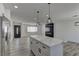Open-concept kitchen flows into the living area, showcasing the kitchen island and sleek design at 1901 Farnam Pl, Las Vegas, NV 89102