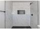 Modern shower features marble style tiling, a shower niche, and sleek black hardware at 1901 Farnam Pl, Las Vegas, NV 89102