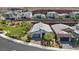 A modern home with well-maintained landscaping is viewed from above in a desert community near the mountains at 1957 Regal Bluff Dr, Henderson, NV 89052