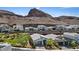 Scenic aerial view of a modern home with mountain views, surrounded by landscaped greenery in a desert community at 1957 Regal Bluff Dr, Henderson, NV 89052