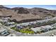 A bird's-eye view shows homes against a mountain backdrop, with well-maintained lawns and desert landscaping at 1957 Regal Bluff Dr, Henderson, NV 89052