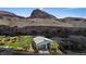 Scenic aerial view of a single-story home nestled against a stunning mountain backdrop at 1957 Regal Bluff Dr, Henderson, NV 89052