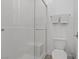 A bathroom featuring a glass enclosed shower with a bench seat and toilet, offering a modern design at 1957 Regal Bluff Dr, Henderson, NV 89052