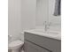 A half bath offering a modern vanity with gray cabinets, a white countertop, and an elegant silver faucet at 1957 Regal Bluff Dr, Henderson, NV 89052