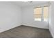 Empty bedroom with two large windows allowing ample natural light and plush gray carpeting at 1957 Regal Bluff Dr, Henderson, NV 89052