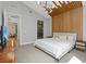 Bright primary bedroom with stylish decor, wood accent wall, and serene ambiance at 1957 Regal Bluff Dr, Henderson, NV 89052