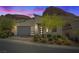 Charming single-story home featuring modern architectural design and desert landscaping at 1957 Regal Bluff Dr, Henderson, NV 89052