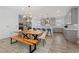 Open kitchen features a live edge wood dining table, a large island with seating and stainless steel appliances at 1957 Regal Bluff Dr, Henderson, NV 89052