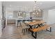 Open kitchen features a live edge wood dining table, a large island with seating, and modern gray cabinets at 1957 Regal Bluff Dr, Henderson, NV 89052