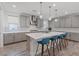 Modern kitchen features an island with counter seating, pendant lighting, and stainless steel appliances at 1957 Regal Bluff Dr, Henderson, NV 89052