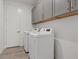 Laundry room with stacked washer and dryer, upper cabinets, and a bright, clean aesthetic at 1957 Regal Bluff Dr, Henderson, NV 89052