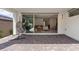 Spacious covered patio with stylish brick pavers, hanging egg chair, and view to the indoor living space at 1957 Regal Bluff Dr, Henderson, NV 89052