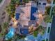 This aerial shot showcases the pool, fire pit, solar panels and surrounding lush greenery at 2086 Troon Dr, Henderson, NV 89074