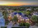 Stunning aerial view of the home with solar panels, lush landscaping, and a beautiful city skyline at 2086 Troon Dr, Henderson, NV 89074