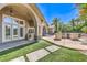 Outdoor kitchen and patio area with artificial grass and plenty of shade at 2086 Troon Dr, Henderson, NV 89074