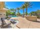 Backyard with a swimming pool, an outdoor kitchen, lounge chairs and palm trees at 2086 Troon Dr, Henderson, NV 89074