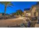This backyard patio includes comfortable seating and an outdoor fire pit, perfect for entertaining guests at 2086 Troon Dr, Henderson, NV 89074