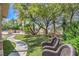 Lush backyard with green grass, mature landscaping, and an outdoor kitchen at 2086 Troon Dr, Henderson, NV 89074