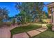 A serene backyard oasis with lush greenery, mature trees, and manicured landscaping at 2086 Troon Dr, Henderson, NV 89074