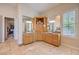 Bathroom with dual sinks, wooden cabinets and countertops, walk-in closet access, and modern fixtures at 2086 Troon Dr, Henderson, NV 89074