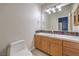 Bathroom featuring tiled counter with colorful tile design and wood cabinets at 2086 Troon Dr, Henderson, NV 89074