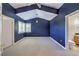 Spacious bedroom with tray ceiling, blue walls, and an attached bathroom at 2086 Troon Dr, Henderson, NV 89074