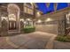 Stately home exterior showcases a manicured lawn, stone accents, a three-car garage, and a grand entrance at 2086 Troon Dr, Henderson, NV 89074