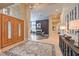 Grand foyer with ornate wood door, tiled flooring, elegant lighting, and a decorative console table at 2086 Troon Dr, Henderson, NV 89074