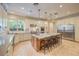 Bright kitchen boasts a large island with seating, stainless steel appliances, and granite counters at 2086 Troon Dr, Henderson, NV 89074