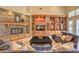 Cozy living room showcasing a stone fireplace, custom shelving, and comfortable seating at 2086 Troon Dr, Henderson, NV 89074