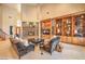Inviting living room features a stone fireplace, custom built-ins, and plush seating for a comfortable atmosphere at 2086 Troon Dr, Henderson, NV 89074