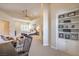 Open-concept main bedroom featuring a sitting area, built-in shelving, and access to en-suite bathroom at 2086 Troon Dr, Henderson, NV 89074