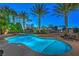 Sparkling swimming pool with attached spa and mature palms offer a relaxing outdoor retreat at 2086 Troon Dr, Henderson, NV 89074