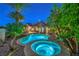 Beautiful backyard featuring a uniquely shaped pool, spa, and lush landscaping, creating a serene retreat at 2086 Troon Dr, Henderson, NV 89074