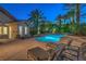 Inviting backyard pool and spa surrounded by lush landscaping and lounge chairs create a private oasis at 2086 Troon Dr, Henderson, NV 89074