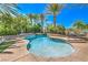 A private backyard pool with waterfall feature surrounded by lush landscaping at 2086 Troon Dr, Henderson, NV 89074