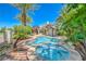 A backyard pool features a spa, mature trees, and is surrounded by lush landscaping at 2086 Troon Dr, Henderson, NV 89074