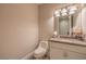 Powder room with a white vanity and a decorative mirror at 2086 Troon Dr, Henderson, NV 89074