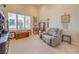 Sitting room with a comfortable armchair, high ceilings, and a view of the yard at 2086 Troon Dr, Henderson, NV 89074