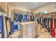 Custom walk-in closet featuring built-in shelving and drawers for organizing wardrobe essentials at 2086 Troon Dr, Henderson, NV 89074
