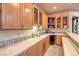 Wet bar with wood cabinets, tile backsplash, and small refrigerator at 2086 Troon Dr, Henderson, NV 89074